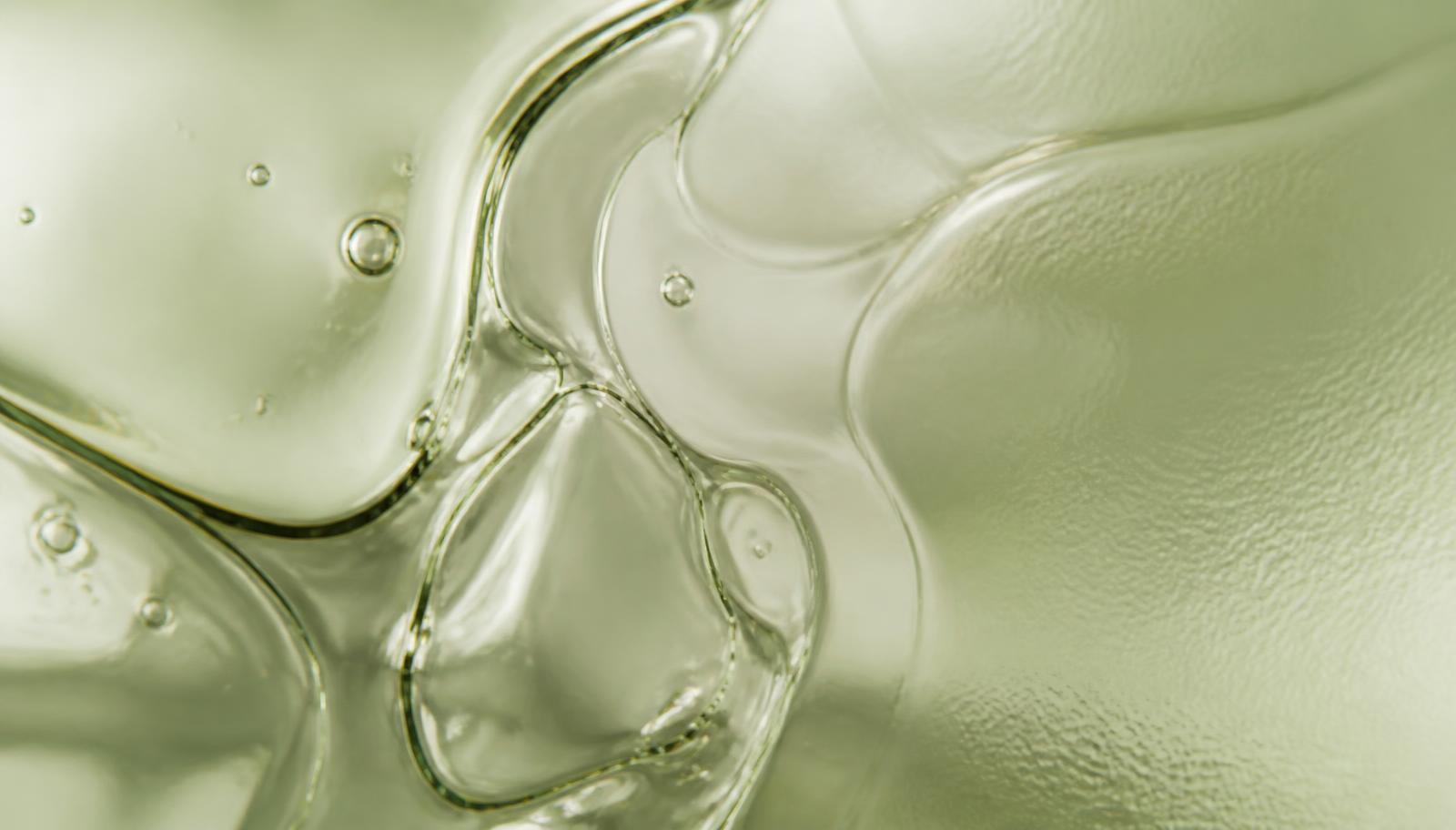 Abstract macro texture of liquid refraction in sage tones
